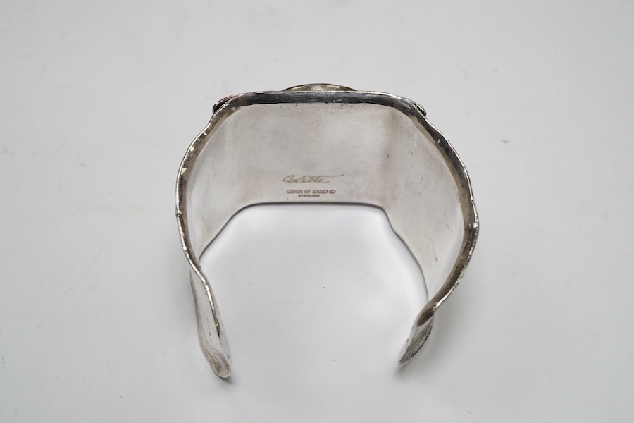 A modern Macy's of New York sterling and polychrome enamel 'Grain of Sand' bangle, gross 83 grams. Condition - poor to fair